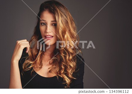 Woman, beauty and hair care portrait in studio with makeup, cosmetics and skin glow on a grey background. Face of aesthetic female model person with salon results, shine and style with mockup space 134396112