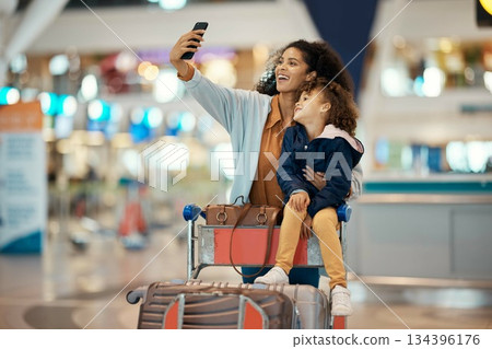 Travel, selfie and smile with mother and daughter in airport for social media, holiday and global journey. Smile, luggage and phone with mom and child picture for vacation, departure and technology Travel, selfie and smile with mother and daughter in airport for social media, holiday and global journey. Smile, luggage and phone with mom and child picture for vacation, departure and technology 134396176