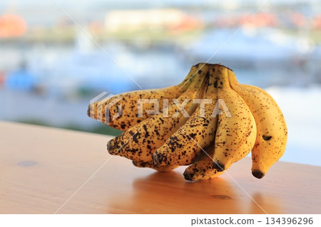 Small bananas on a wooden table Small bananas on a wooden table 134396296