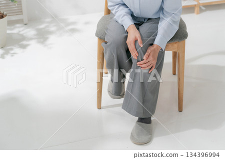 Woman holding her knees 134396994