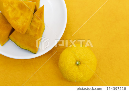 Yuzu placed on a yellow Japanese paper background and cut pumpkin on a white plate Image of the winter solstice Yuzu placed on a yellow Japanese paper background and cut pumpkin on a white plate Image of the winter solstice 134397216