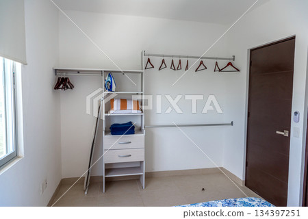 Organized White Closet with Shelves and Folded Towels 134397251