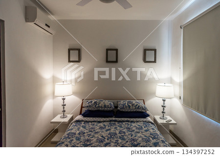 Cozy Bedroom with Soft Lighting and Blue Bedding 134397252