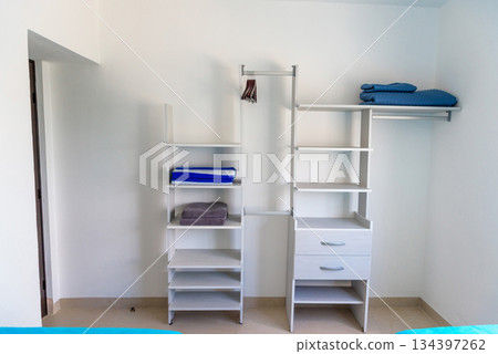 Organized White Closet with Shelves and Folded Towels Organized White Closet with Shelves and Folded Towels 134397262
