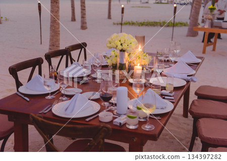 Elegant Outdoor Dining Setup with Floral Centerpiece 134397282