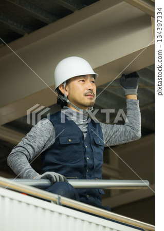 Workers assembling single-tube pipes at a factory site 134397334