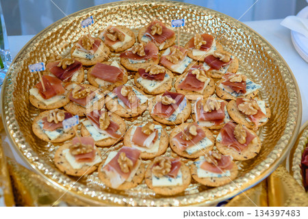 Catering gourmet salt cookies platter with jamon serrano and nuts Catering gourmet salt cookies platter with jamon serrano and nuts 134397483