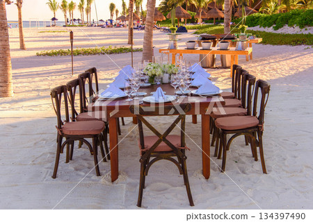 Elegant Beach Dinner Setup at Sunset 134397490