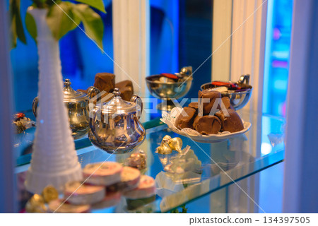vintage dessert table with cookies chocolates and pink roses vintage dessert table with cookies chocolates and pink roses 134397505