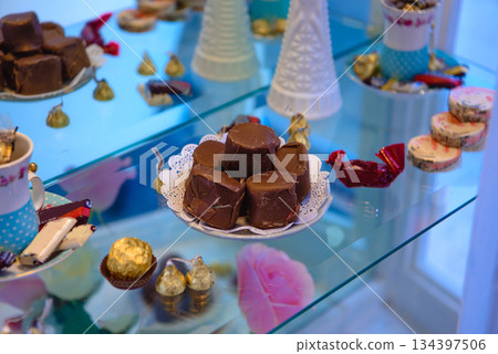vintage dessert table with cookies chocolates and pink roses vintage dessert table with cookies chocolates and pink roses 134397506