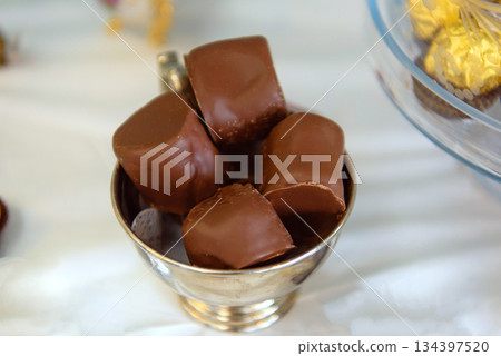 Chocolate-Covered Marshmallow Dessert on White Party Table Chocolate-Covered Marshmallow Dessert on White Party Table 134397520