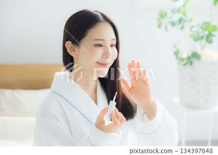 A woman sitting on a bed A woman sitting on a bed 134397648