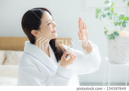 A woman sitting on a bed A woman sitting on a bed 134397649