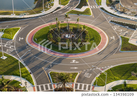 Traffic circle on American road with driving cars. Overhead view of US roundabout intersection 134398109