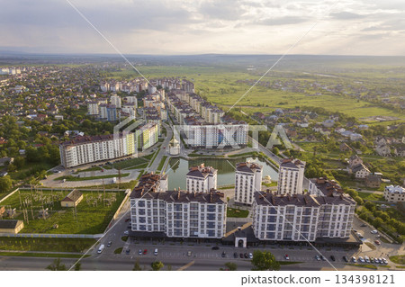 Top view of urban developing city landscape with tall apartment buildings and suburb houses. Drone aerial photography. 134398121