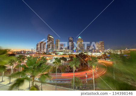 Tampa, Florida. Cars traffic driving on wide highway and high skyscraper buildings in downtown district. American city with business financial district at nightfall. Tampa, Florida. Cars traffic driving on wide highway and high skyscraper buildings in downtown district. American city with business financial district at nightfall. 134398146