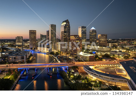 Tampa, Florida. Cars traffic driving on highway bridge and high skyscraper buildings in downtown district. American city with business financial district at nightfall Tampa, Florida. Cars traffic driving on highway bridge and high skyscraper buildings in downtown district. American city with business financial district at nightfall 134398147
