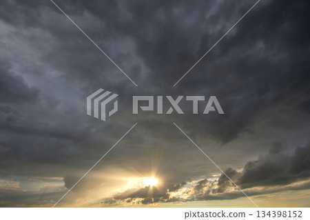 Sunset sky covered with dramatic storm puffy clouds before rain. 134398152