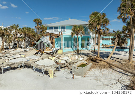 Storm surge caused by hurricane wind severe damaged residential houses on ocean shore. Natural disaster consequences in Florida 134398172