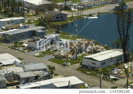 Severely damaged houses after hurricane Ian in Florida mobile home residential area. Consequences of natural disaster 134398190