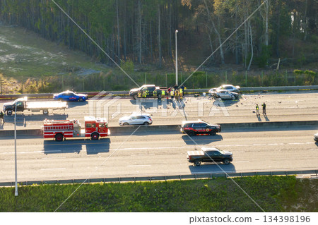Severe car accident on American freeway. Emergency services helping victims of vehicle crash on highway road in USA. 134398196