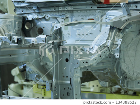 A welding robot in action at a site where car bodies are welded A welding robot in action at a site where car bodies are welded 134398522