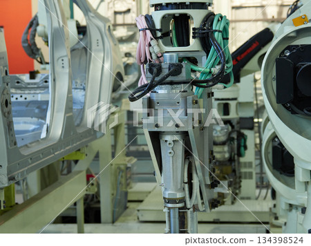 A welding robot in action at a site where car bodies are welded 134398524