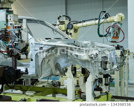 A welding robot in action at a site where car bodies are welded A welding robot in action at a site where car bodies are welded 134398536