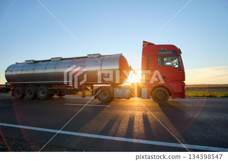 Petrol cargo truck driving on highway hauling oil products. Delivery transportation and logistics concept 134398547