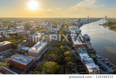 Panoramic cityscape with River Street old historical architecture in Savannah, Georgia. Southern American architecture in evening Panoramic cityscape with River Street old historical architecture in Savannah, Georgia. Southern American architecture in evening 134398555