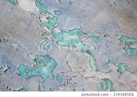 Old cracked abstract grunge vintage texture copy space background, retro pattern. White irregular spots paint peeling of light blue concrete or wooden wall or ceiling flat surface. 134398568