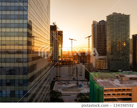 New construction site in Miami, Florida au sunset. Developing residence in American urban area. Concept of housing growth in the USA New construction site in Miami, Florida au sunset. Developing residence in American urban area. Concept of housing growth in the USA 134398592