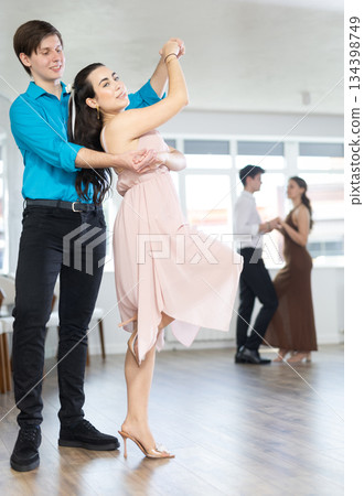 Couple learn to dance latin american dance bachata in studio 134398749