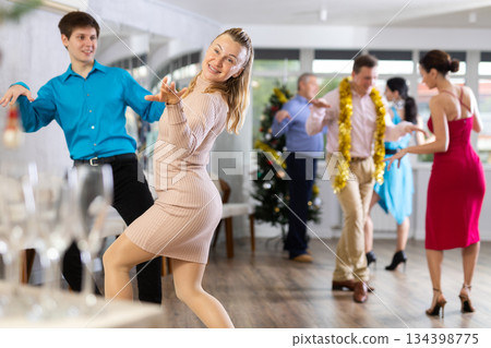 People dancing foxtrot during Christmas or New Year celebration 134398775