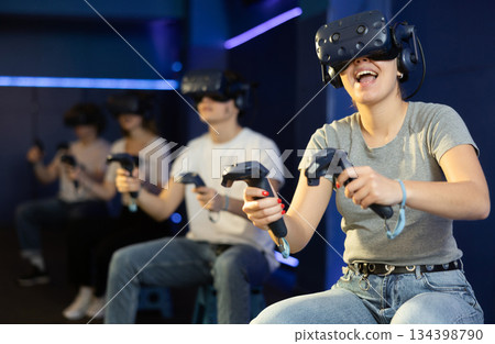 girl in virtual reality glasses controls superhero with joystick in exciting action game simulator 134398790