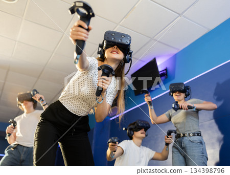 girl in vr helmet act and escape flying asteroids during space adventure game.bottom view girl in vr helmet act and escape flying asteroids during space adventure game.bottom view 134398796