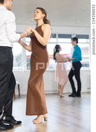 During rehearsal, guy and girl participants of dance workshop perform figure waltz 134398832