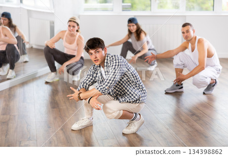 Break dance performed by a group of young dancers in dance studio 134398862