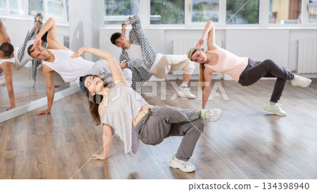 Young girl practicing breakdance in training hall Young girl practicing breakdance in training hall 134398940