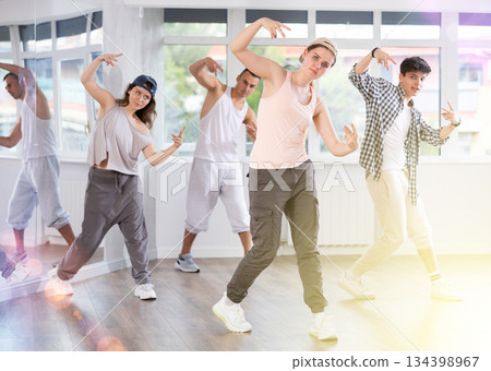 Young girl practicing basic hip hop moves in training hall 134398967