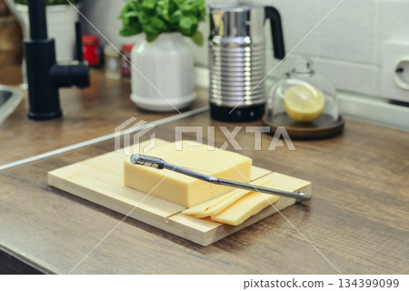 Bamboo cutting board with a built-in cheese cutting device 134399099