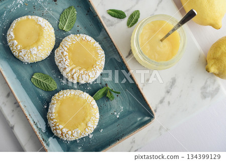Lemon crackle cookies with lemon curd Lemon crackle cookies with lemon curd 134399129
