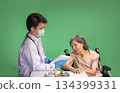 Chroma key, nurse doing vaccine injection to senior woman. 134399331