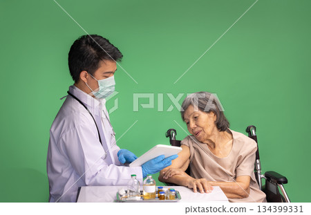 Chroma key, nurse doing vaccine injection to senior woman. 134399331