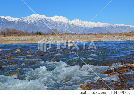 Takase River and the Northern Alps on a clear winter day Takase River and the Northern Alps on a clear winter day 134399702