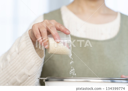 一位老婦人在廚房準備煮飯。 134399774