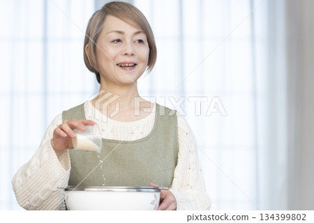 Senior woman preparing to cook rice in the kitchen Senior woman preparing to cook rice in the kitchen 134399802