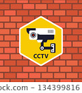 A sticker on a brick wall indicates video surveillance. 134399816
