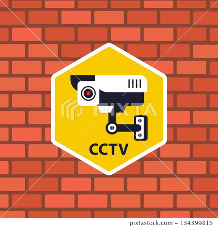 A sticker on a brick wall indicates video surveillance. 134399816
