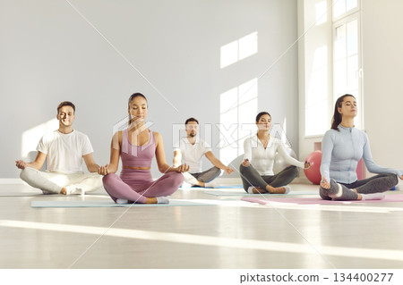 Yoga lotus pose people learning basic poses, breathing techniques, mindfulness practice Yoga lotus pose people learning basic poses, breathing techniques, mindfulness practice 134400277